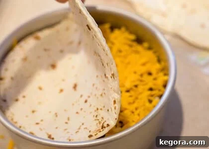 Effortless Instant Pot Taco Bake 7 Final tortilla placed on top of the taco pie layers