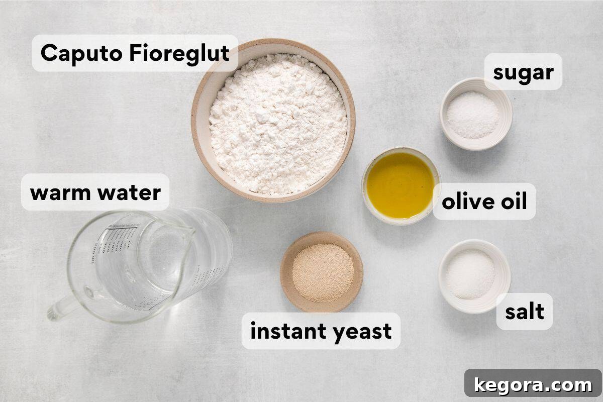 Artisan bread ingredients laid out and measured, including flour, salt, sugar, yeast, water, and olive oil, ready for baking.
