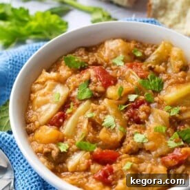 Instant Pot Unstuffed Cabbage Rolls, served in a white bowl with a spoon, highlighting its comforting and rustic appeal.