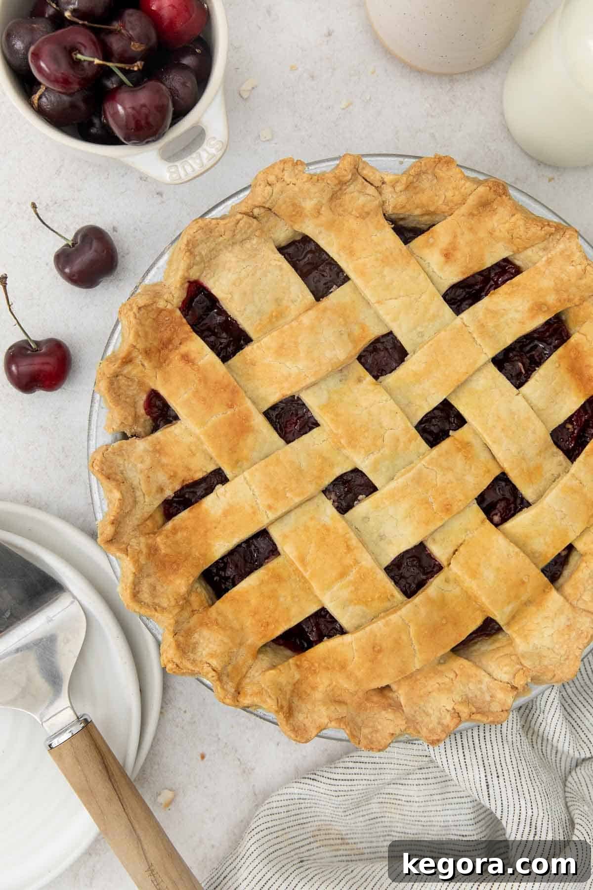Crimson Cherry Dream 11 Overhead view of a stunning Gluten-Free Cherry Pie with a golden lattice crust, glistening with sweet cherry filling peeking through.