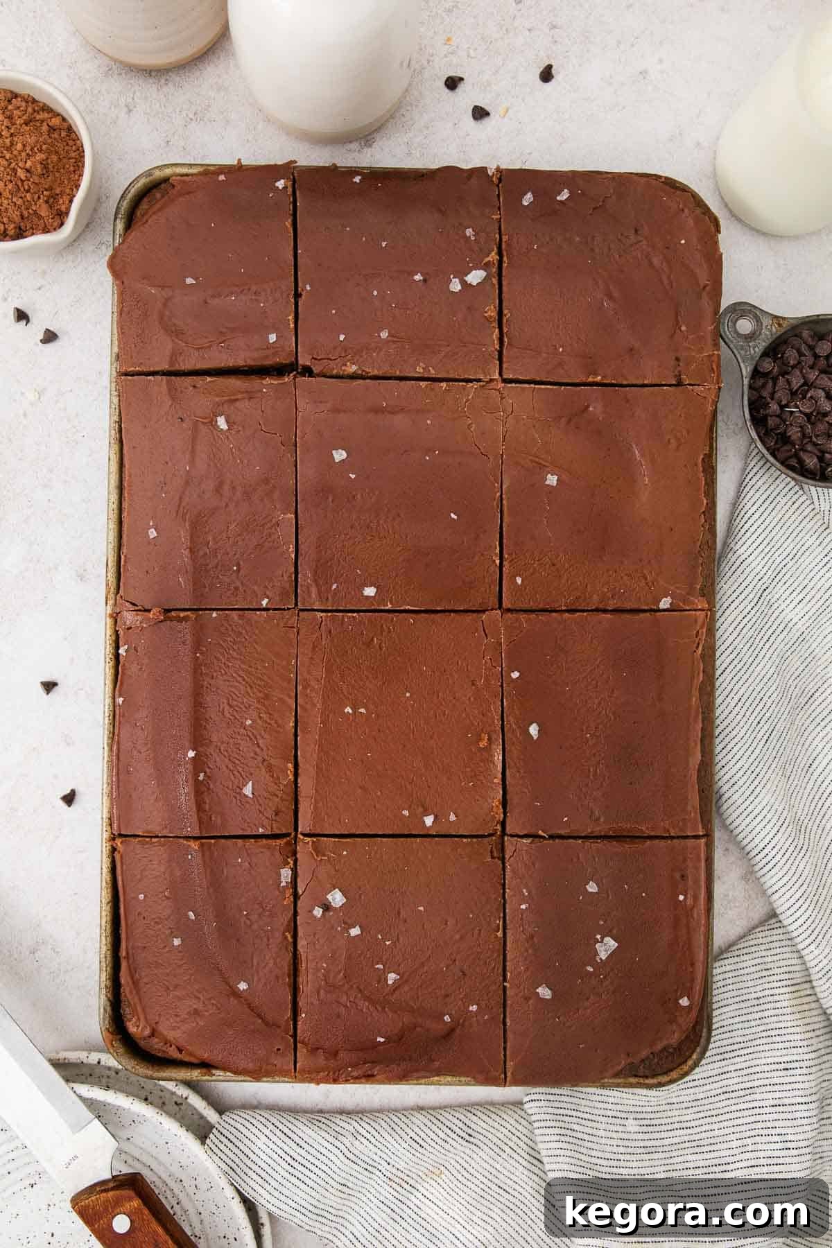 Decadent Gluten-Free Texas Sheet Cake 6 An overhead view of a baked gluten-free Texas sheet cake in its pan, already sliced into neat squares, ready for serving.