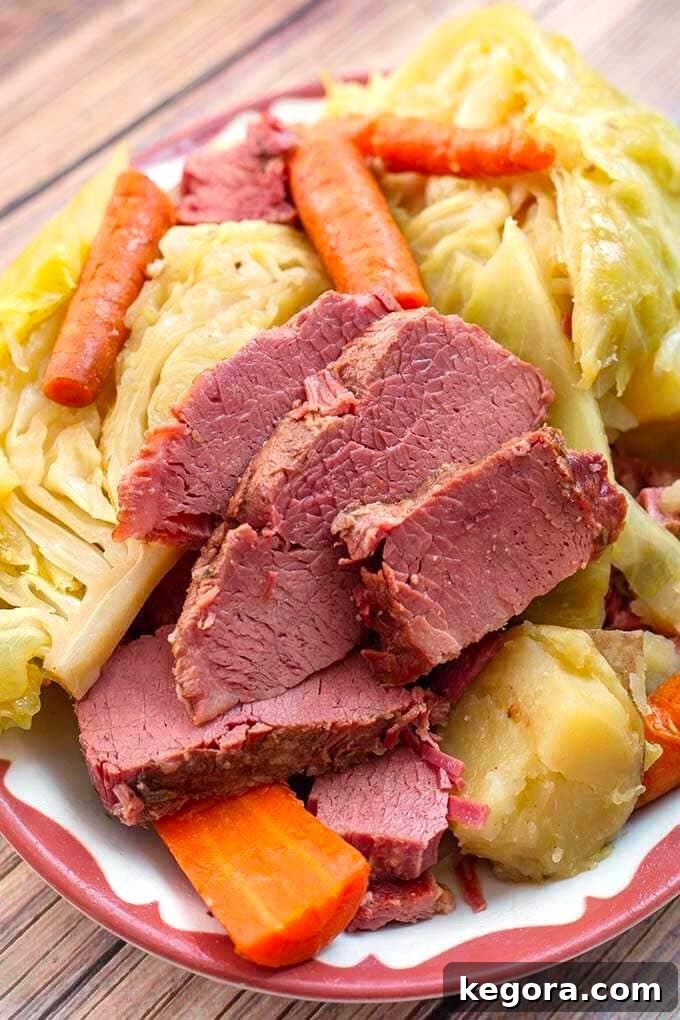 Corned Beef and Cabbage on a white plate with red boarder