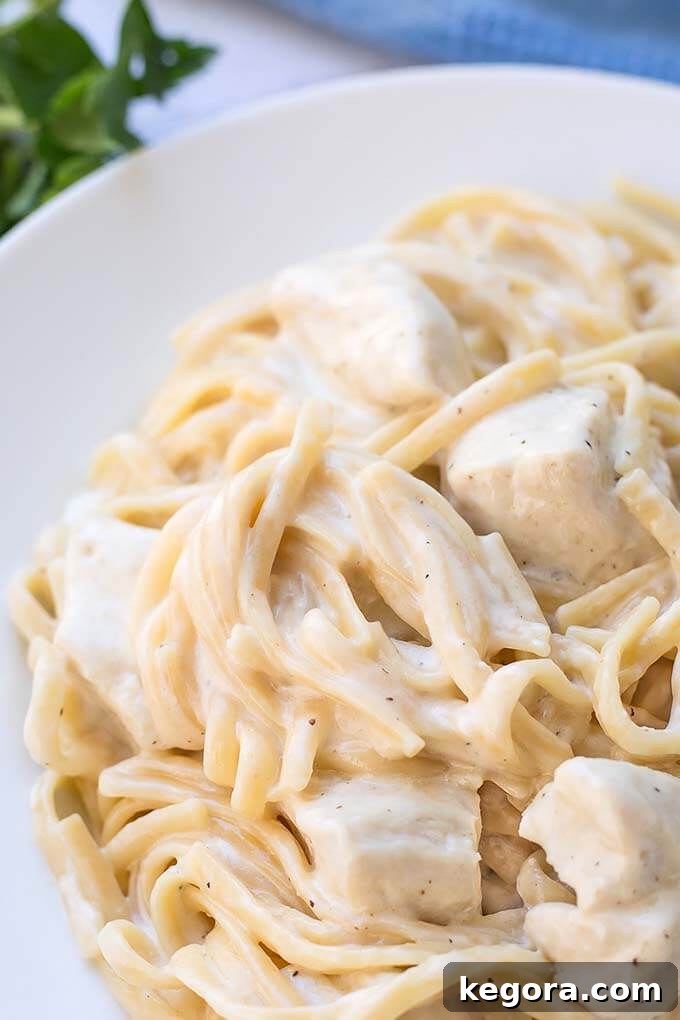 Instant Pot Fettuccine Alfredo with chicken on a white plate