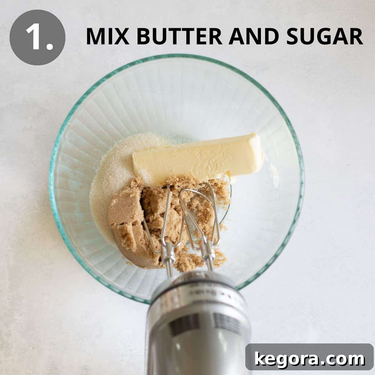 Wholesome Buckwheat Chocolate Chip Delights 5 A glass mixing bowl containing softened butter and both brown and granulated sugars, ready to be creamed together with a hand mixer.