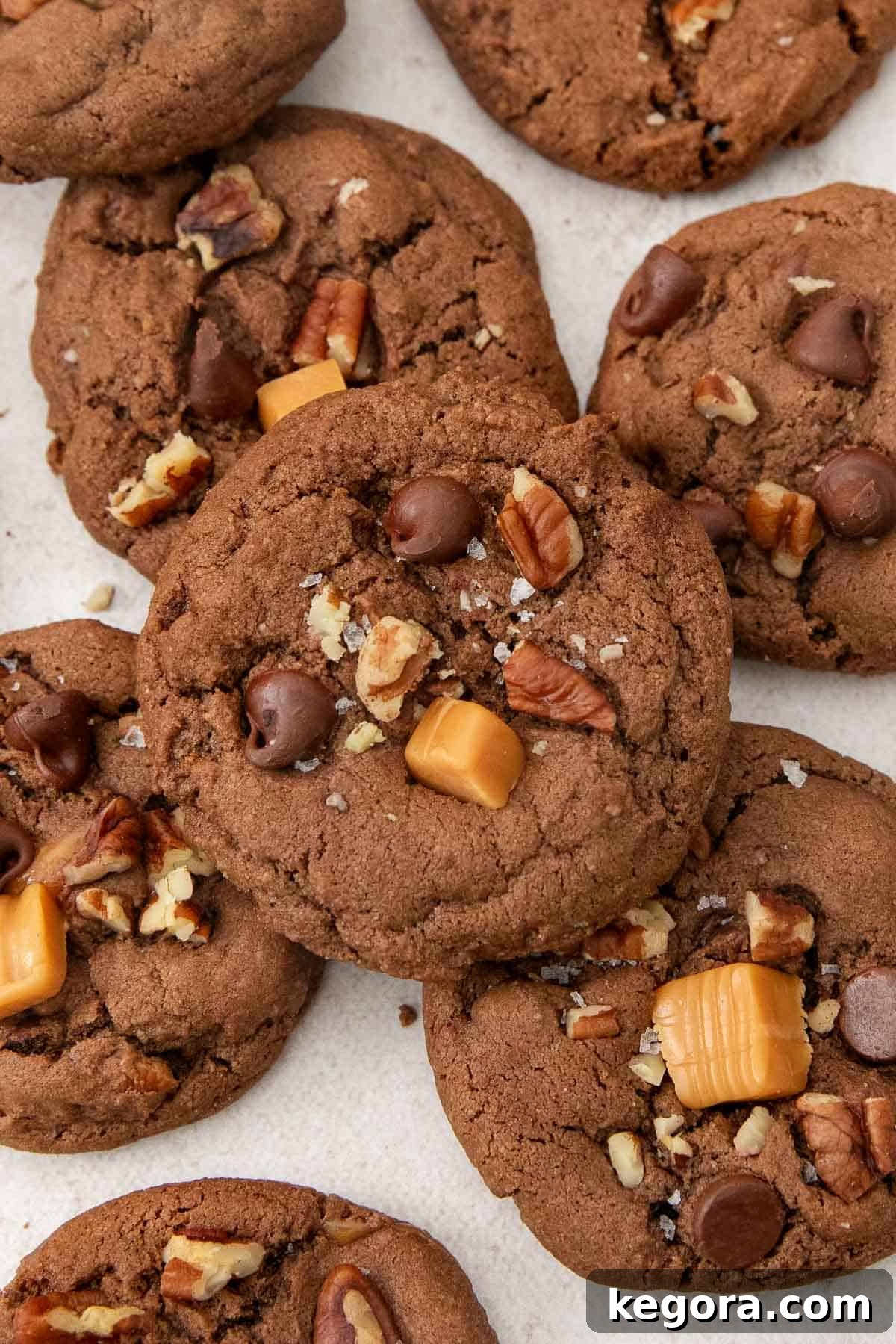 Decadent Gluten-Free Turtle Cookies 6 Delicious layers of chocolate turtle cookies stacked on a countertop, showing their rich texture and abundant fillings.