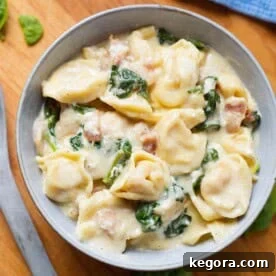 Easy Instant Pot Tortellini Alfredo 7 pressure cooker Tortellini Alfredo in grey bowl on wooden board