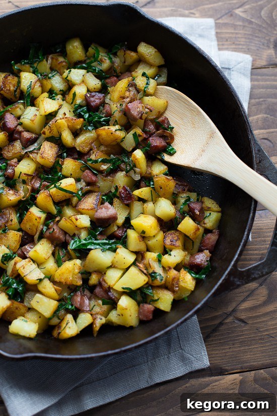 Savory and satisfying Caramelized Shallot, Kale & Sausage Hash served with a fried egg, ready for a delicious breakfast or dinner.