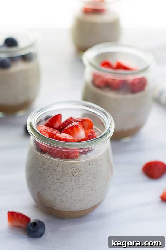 Vanilla Chia Pudding close up shot of 3 chia puddings topped with berries