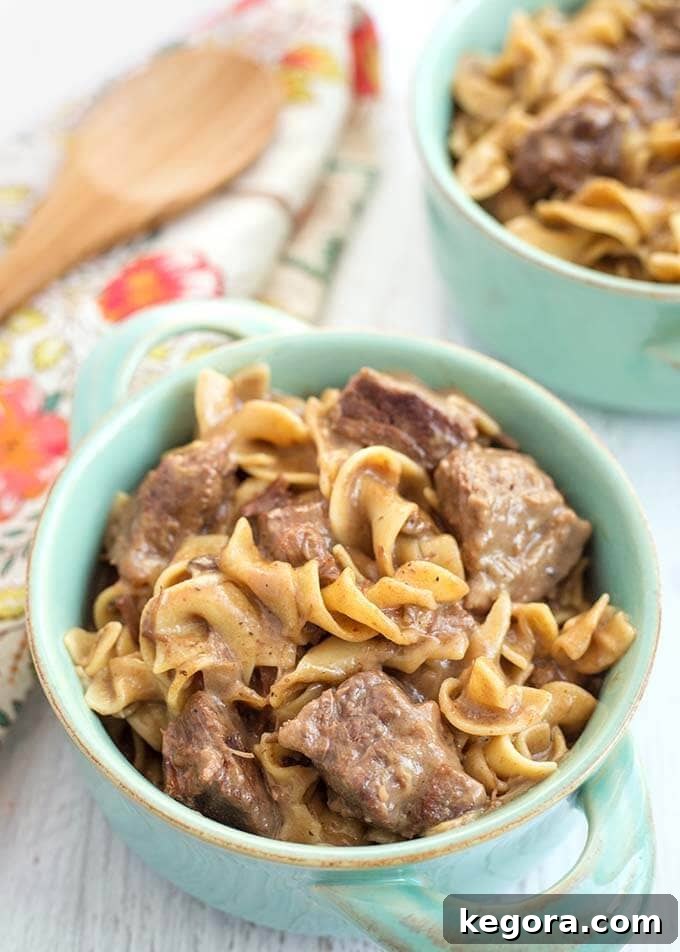 Hearty Instant Pot Beef and Noodles 6 Beef and Noodles in turquoise bowl with handles on light wood background