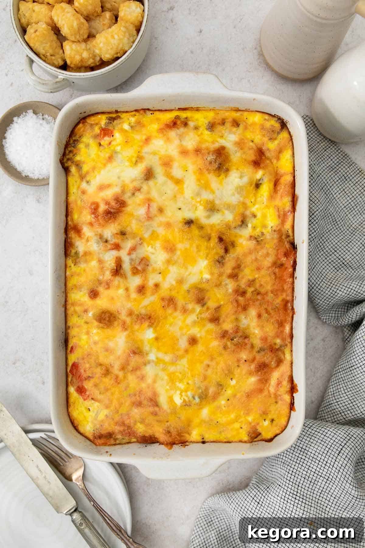 A full gluten-free tater tot breakfast casserole, golden brown and bubbly, presented beautifully in its baking dish, ready to be served.