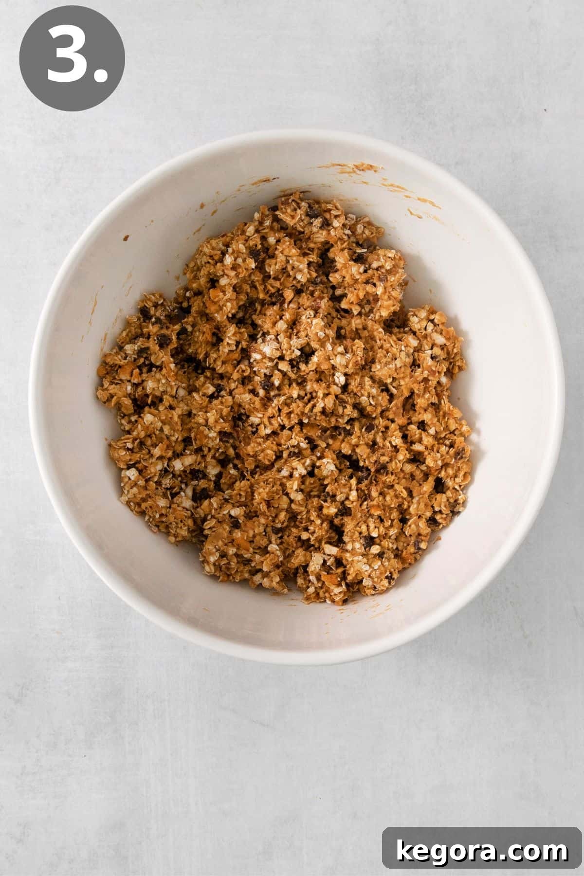 All ingredients for the oatmeal bars mixed together in a large bowl, forming a thick, cohesive dough.
