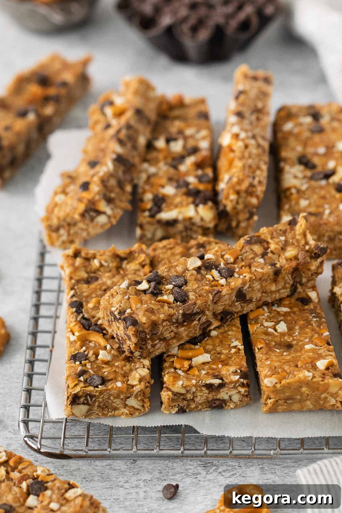 Multiple no-bake peanut butter oatmeal bars stacked and arranged on a wire cooling rack.