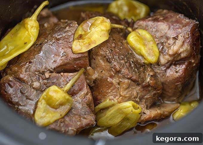 Ultimate Mississippi Slow Cooker Roast 3 Mississippi Pot Roast cooking in a slow cooker, showing the ingredients melding together.