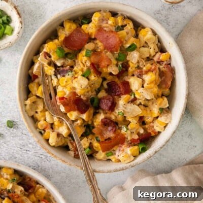 Cream cheese corn in a bowl with a fork