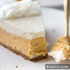 close up shot of pumpkin cheesecake on white plate with gold fork