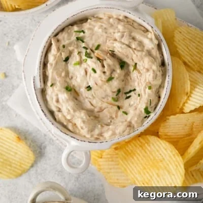 Caramelized onion dip in a bowl with chips on the side