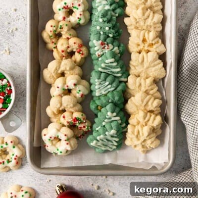 gluten-free spritz cookies lined up on a baking sheet