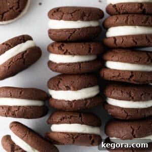 gluten free oreo cookies with cream filling stacked in rows on white background