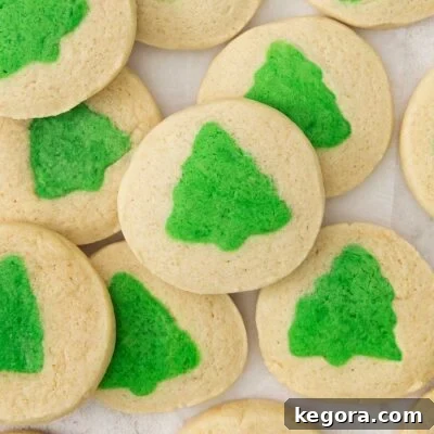 slice and bake cookies with green christmas tress on a countertop.