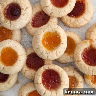 jam-filled thumbprint cookies scattered on a countertop.