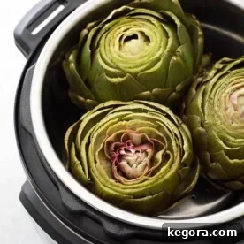 Three Whole Steamed Artichokes in a pressure cooker