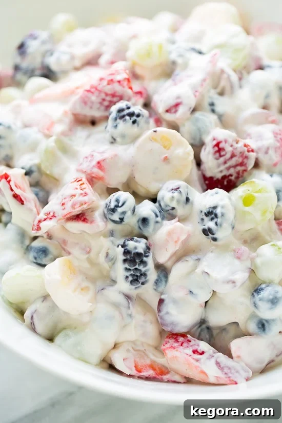 Delicious Healthy Cheesecake Fruit Salad in a serving bowl, perfect for parties.