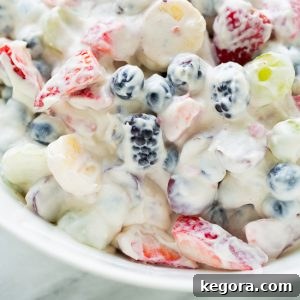A bowl of Healthy Cheesecake Fruit Salad with a vibrant mix of fresh fruits.