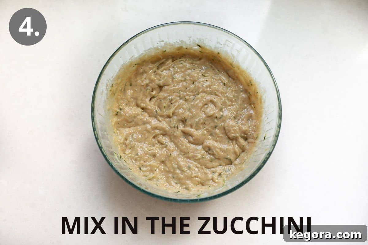 Guilt-Free Zucchini Bread 7 A large mixing bowl filled with perfectly combined zucchini bread batter, showcasing its rich texture.