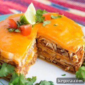 Chicken Taco Pie on a white plate with a piece removed, showing layers of pie
