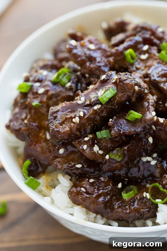 Authentic Teriyaki Beef Close-up image of glistening teriyaki beef garnished with vibrant scallions and toasted sesame seeds