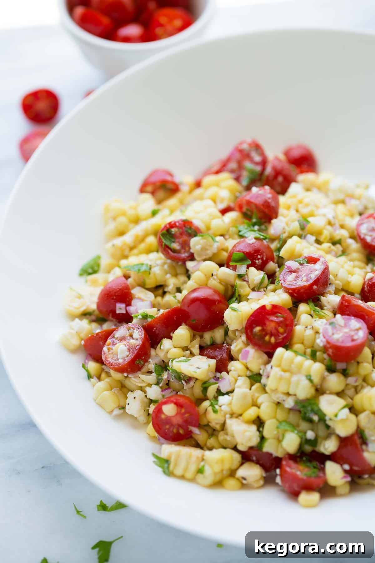 Vibrant Summer Corn Salad in a white bowl, garnished with fresh parsley.