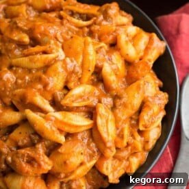 Instant Pot Hearty Cheesy Meat Shells 8 Cheesy Meaty Shells on a black plate, a perfect Instant Pot dinner