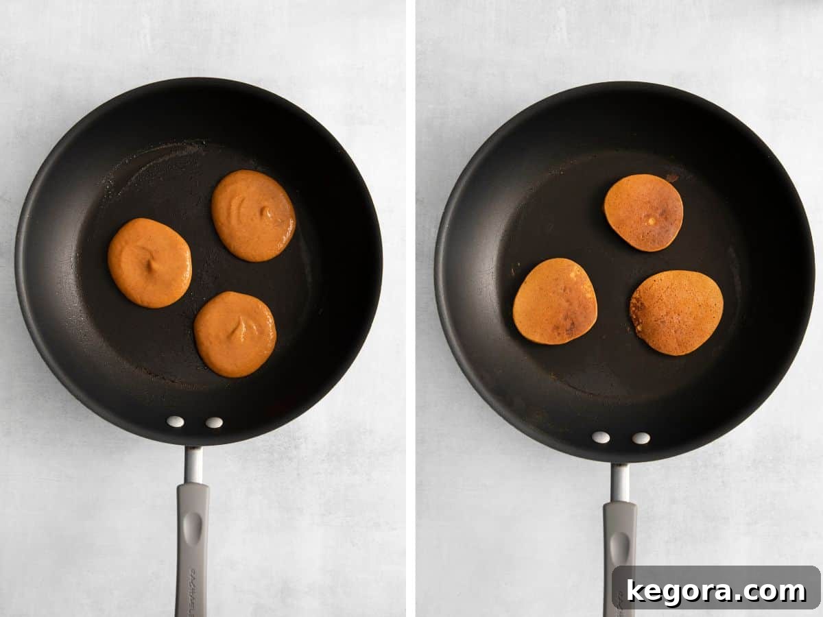 Batter for pumpkin pancakes cooking in a skillet, and a stack of cooked pumpkin pancakes on a plate.