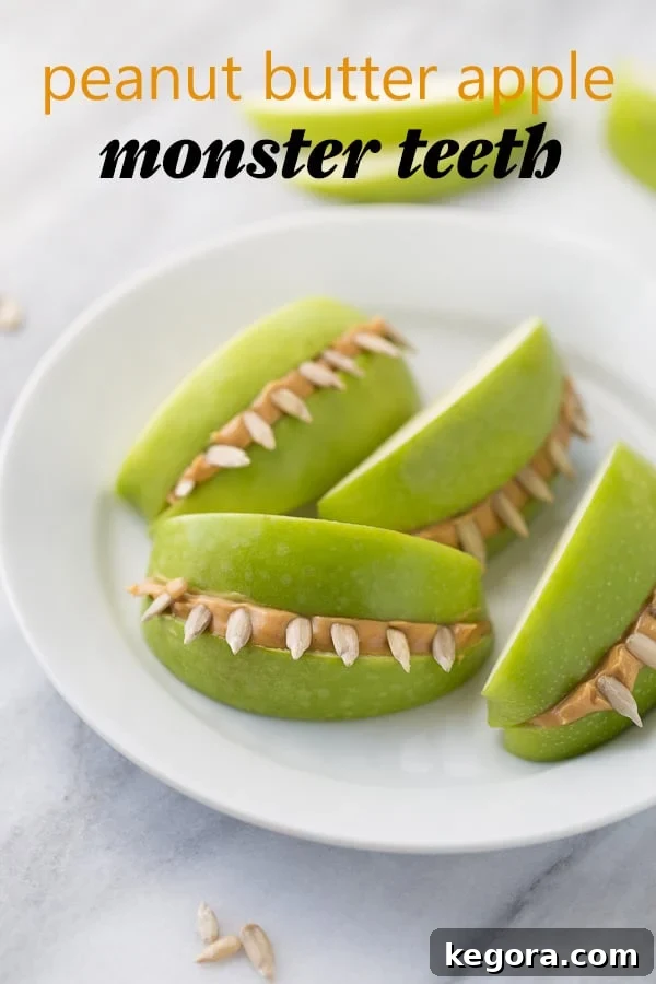 Spooktacularly Healthy Treats 5 Spooky Peanut Butter Apple Monster Teeth displayed on a white plate against a clean marble background.