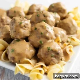 Creamy Instant Pot Swedish Meatballs 8 Instant Pot Swedish Meatballs served over noodles on a white plate, ready to eat.
