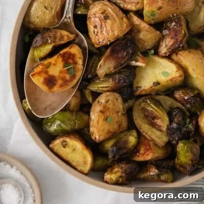 Golden Roast Potatoes with Crispy Brussels Sprouts 9 roasted potatoes and brussel sprouts in a bowl