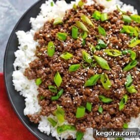 Korean Ground Beef - Bulgogi over white rice on a black plate