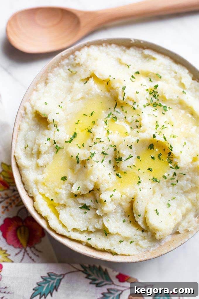 Instant Pot Creamy Cauli Mash 2 Mashed Cauliflower in a beige bowl next to a wooden spoon