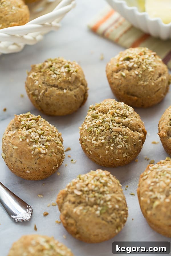 Artisan Gluten-Free Crusty Buns 2 Gluten-free crusty seeded rolls on a marble background, showcasing their golden crust and seeds