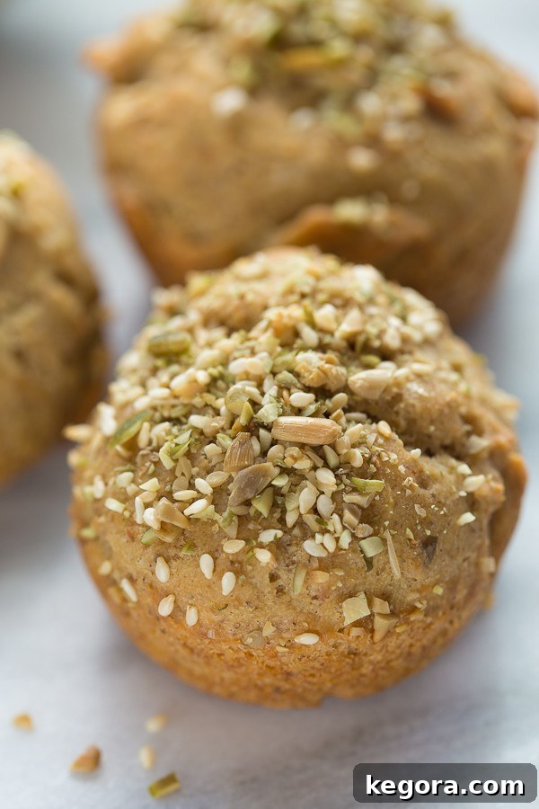 Artisan Gluten-Free Crusty Buns 3 Close-up of golden brown gluten-free crusty seeded rolls cooling on a marble background, highlighting the seeds and texture