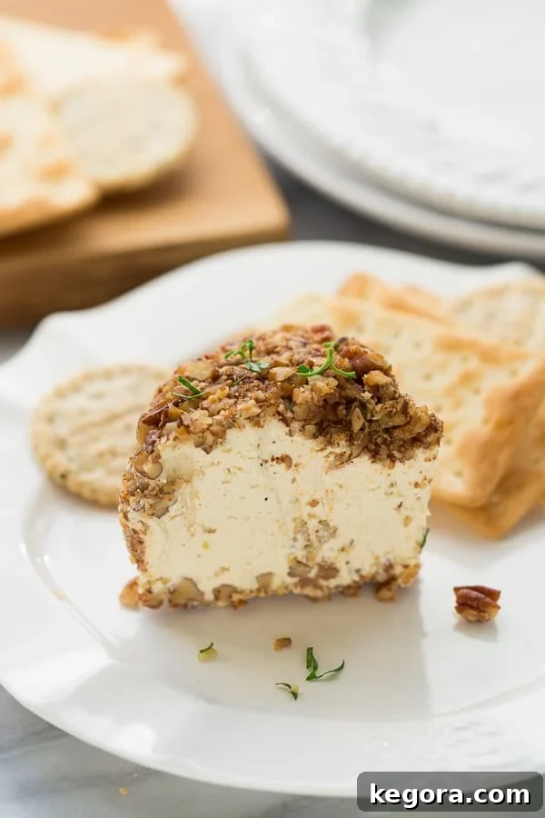 The Ultimate Vegan Party Cheeseball 2 Delicious Vegan Party Cheeseball with crackers and garnishes, perfect for a plant-based appetizer