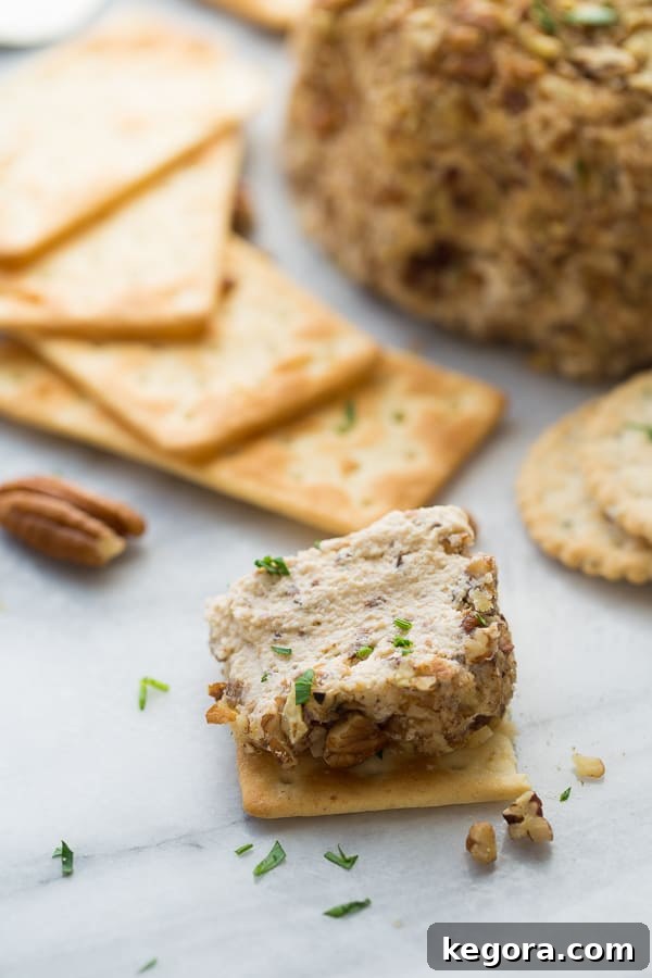The Ultimate Vegan Party Cheeseball 4 Close-up of a Vegan Party Cheeseball coated in toasted pecans, ready for serving