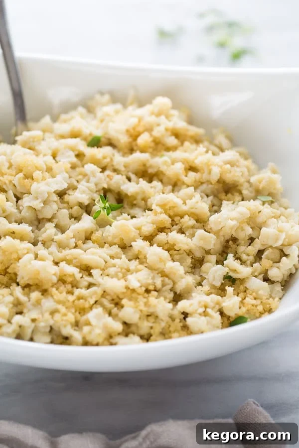 A bowl of delicious gluten-free spaetzle noodles, ready to be served, on a marble background.