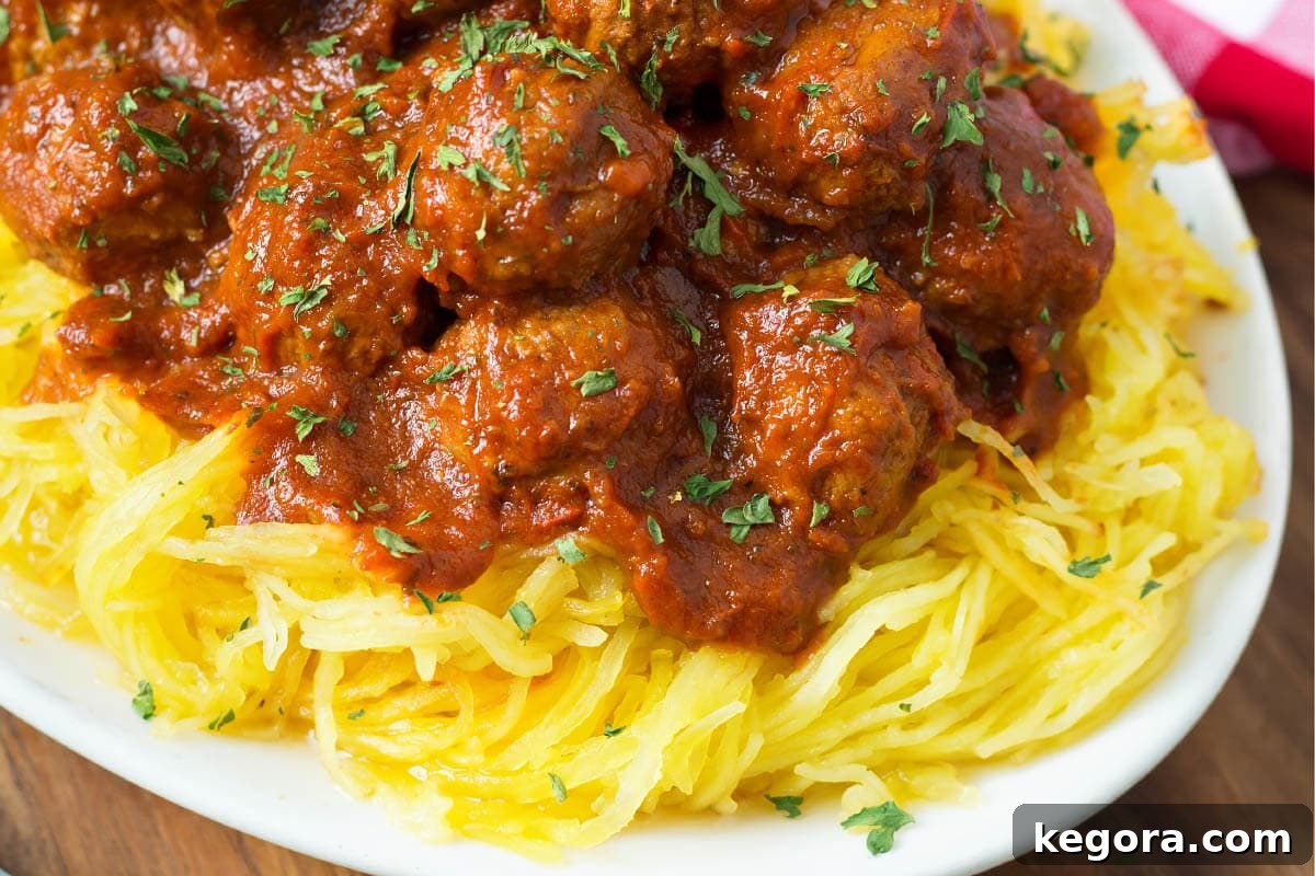 Effortless Slow Cooker Spaghetti Squash and Meatballs 4 Spaghetti Squash and Meatballs on a white plate
