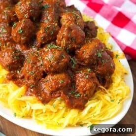 Spaghetti Squash and Meatballs on a white plate next to a red gingham napkin