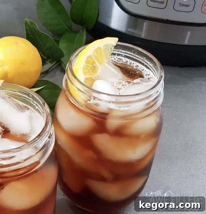 Two mason jars of sweet tea with lemon slices, perfectly chilled and ready for a refreshing sip.