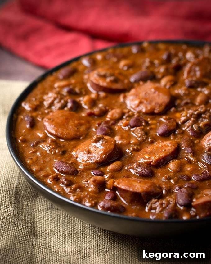 Hearty Cowboy Beans served in a black bowl, garnished and ready to be enjoyed.