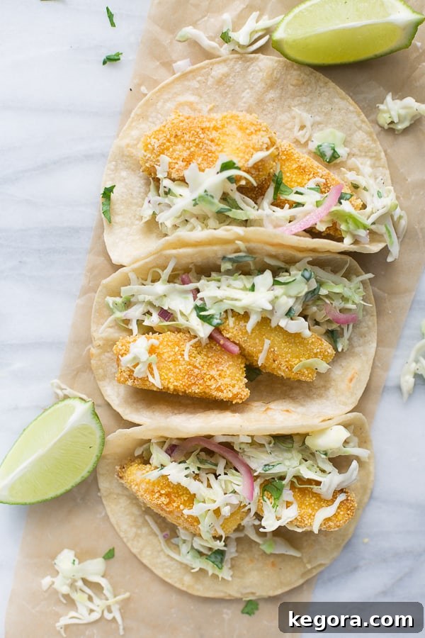 The Ultimate Gluten-Free Fish Tacos 4 Prepared gluten-free fish tacos with fresh cilantro and lime wedges, ready to eat.