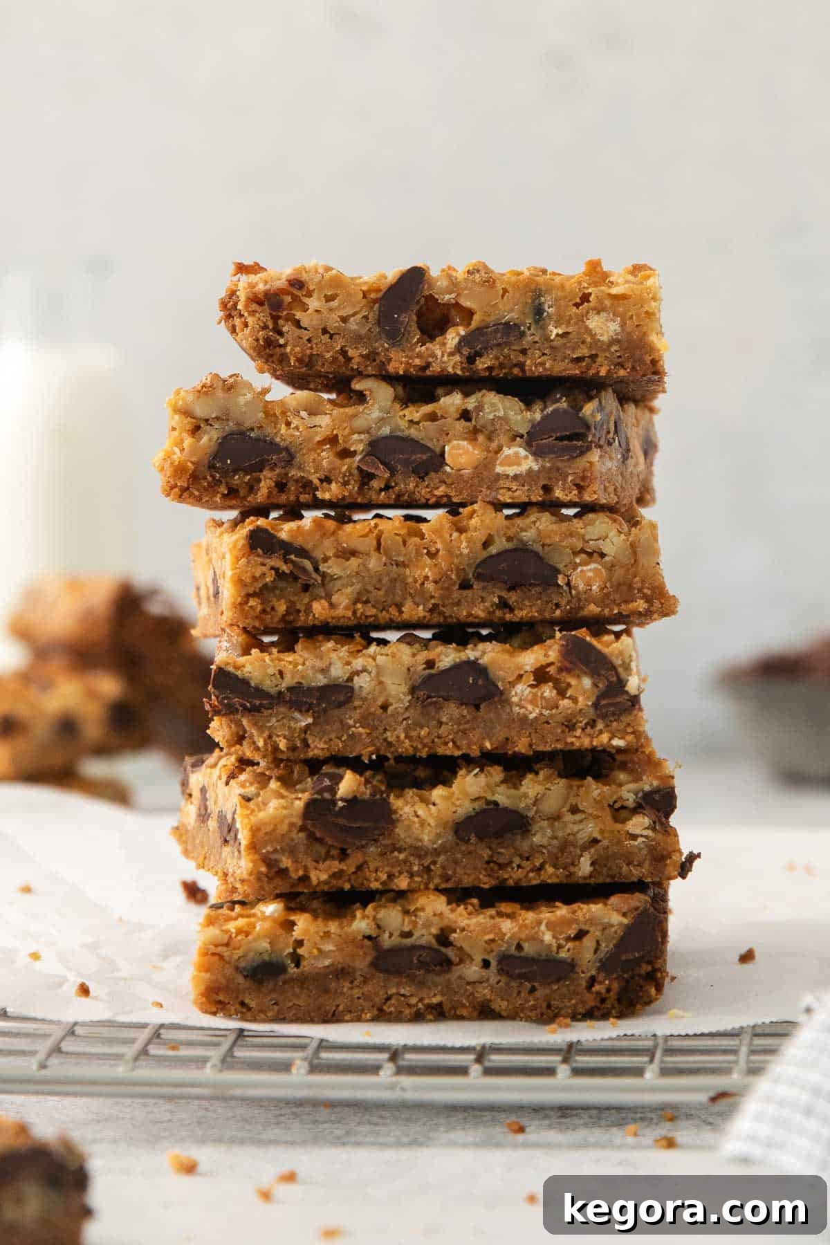 Gluten-Free Magic Bars 2 Seven-layer bars stacked neatly on a cooling rack, showcasing their irresistible layers.