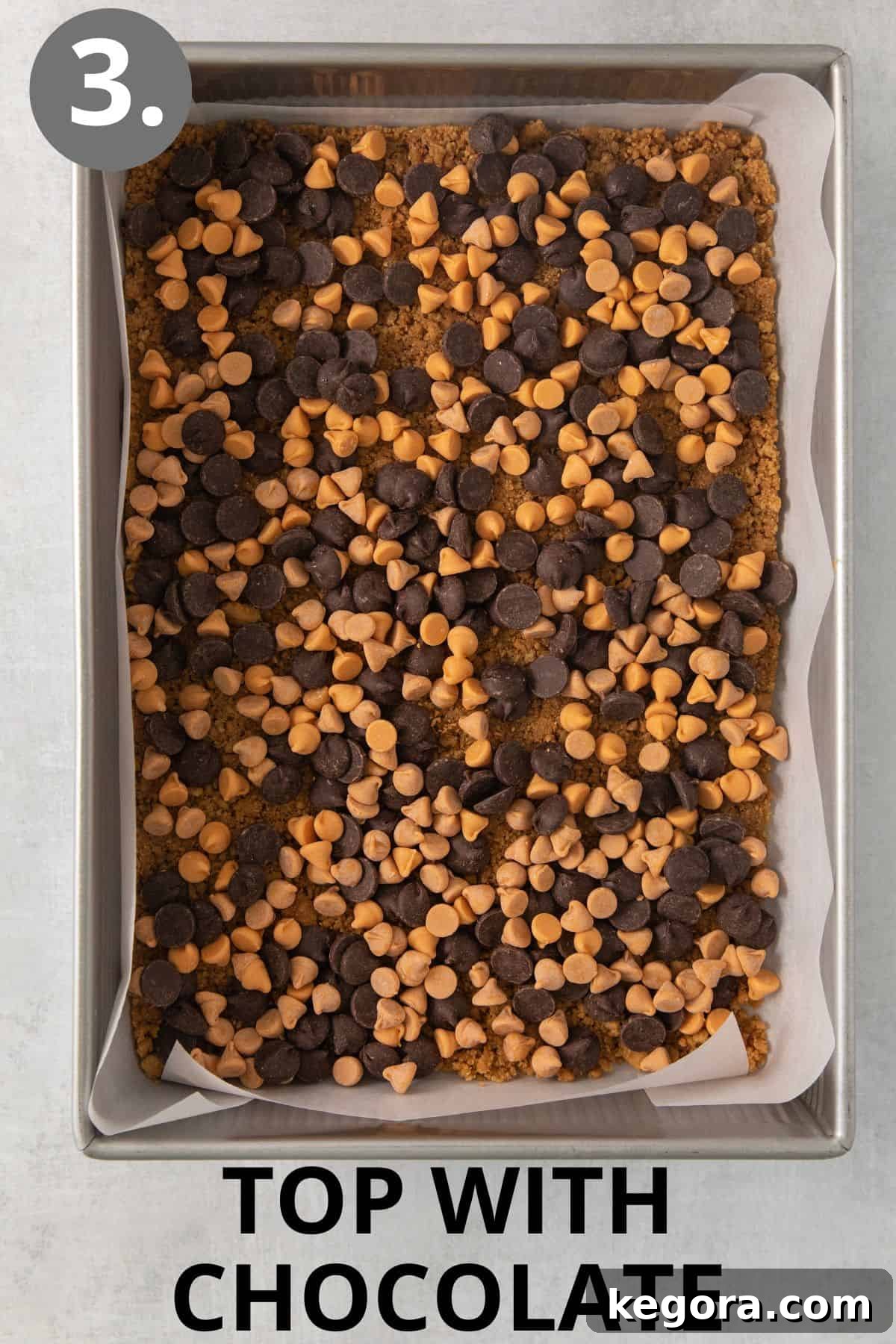 Gluten-Free Magic Bars 6 The baked 7-layer bars crust, now topped with an even layer of chocolate chips, ready for more ingredients.